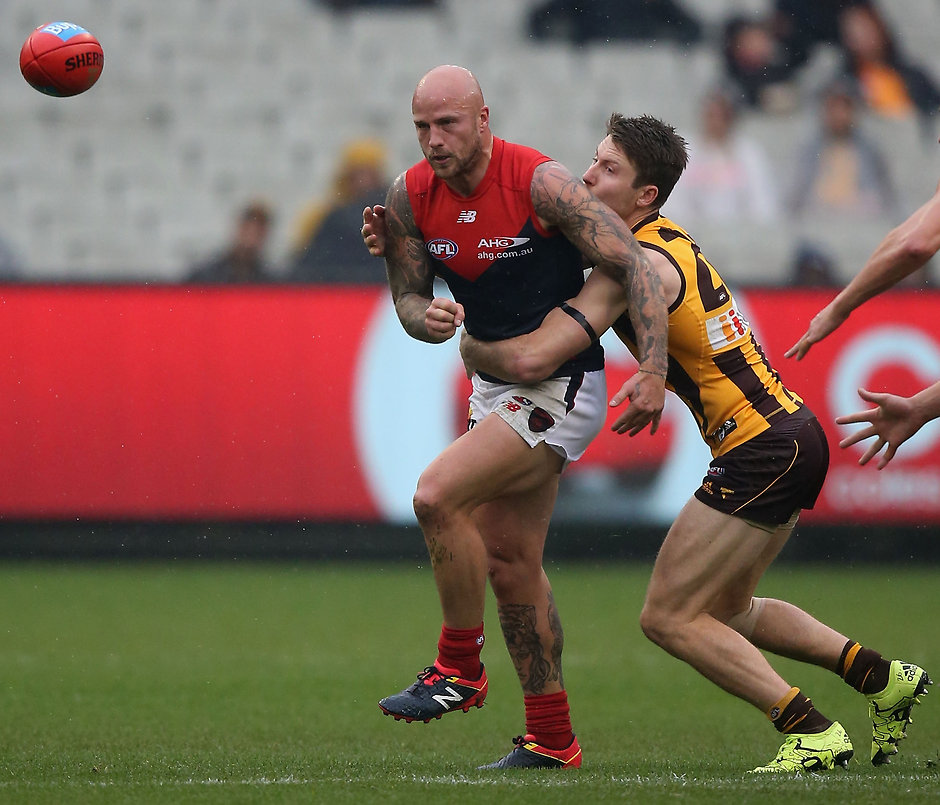 AFL 2016 Rd 11 - Hawthorn v Melbourne MELBOURNE, AUSTRALIA - JUNE 04: Nathan Jones of the Demons is tackled by Luke Breust of the Hawks during the 2016 AFL Round 11 match between the Hawthorn Hawks and the Melbourne Demons at the Melbourne Cricket Ground on June 4, 2016 in Melbourne, Australia. (Photo by Sean Garnsworthy/AFL Media)